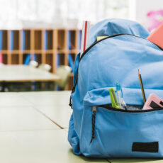 blue-schoolchild-backpack-on-table